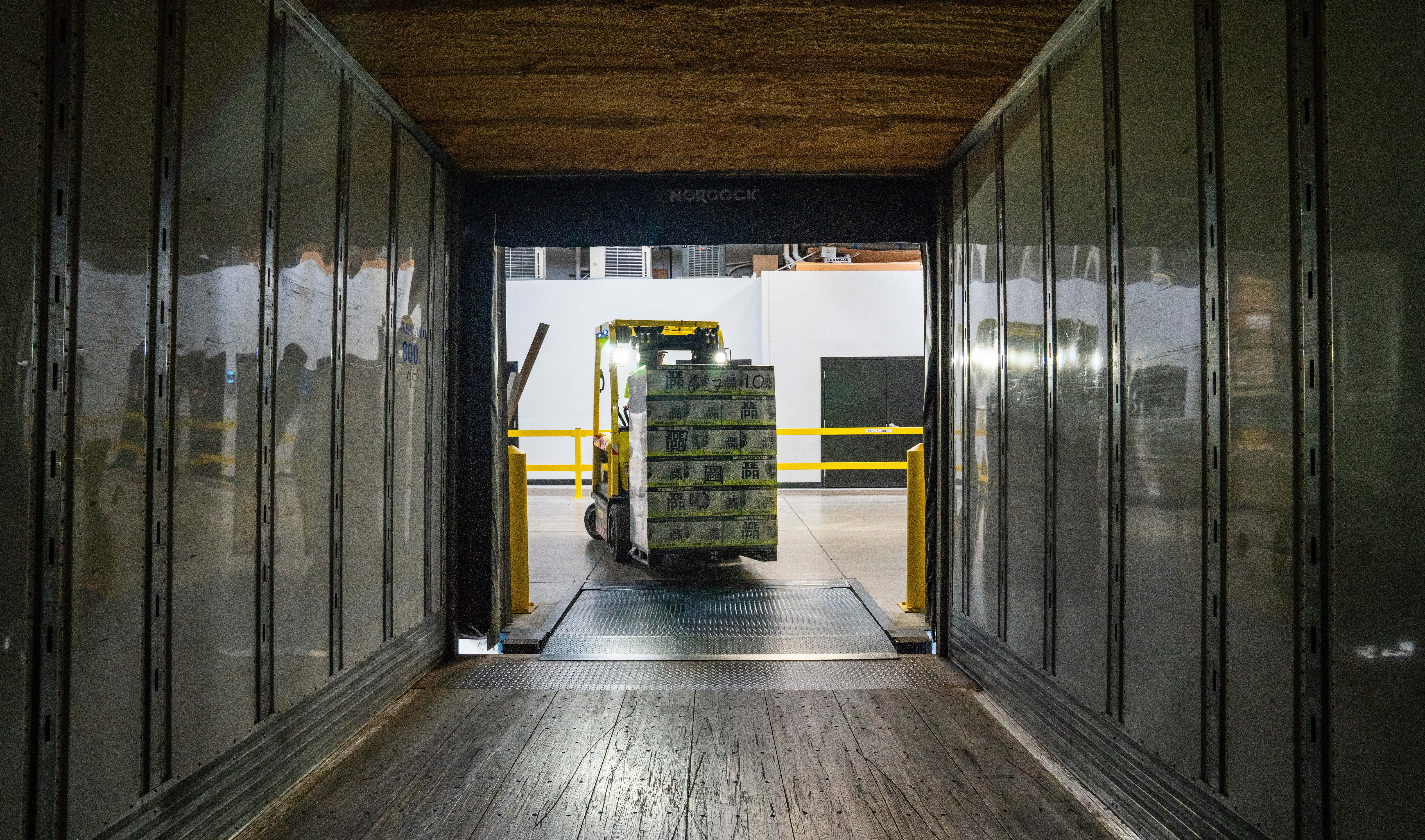 forklift loading a skid on a trailer ready for LTL shipping as part of our logistics solutions.